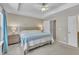 Well-lit bedroom featuring a tray ceiling, ceiling fan, and comfortable furnishings at 342 Westgrove Ct, Durham, NC 27703