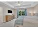 Bright bedroom with a ceiling fan, tray ceiling, dresser, TV and plush carpeting at 342 Westgrove Ct, Durham, NC 27703