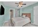 A cozy bedroom featuring soft, light green walls, ceiling fan, and an ensuite bathroom for added convenience at 342 Westgrove Ct, Durham, NC 27703