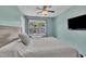 Bright bedroom with a large window and a TV mounted on the wall at 342 Westgrove Ct, Durham, NC 27703