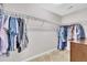 Well-organized walk-in closet with metal shelving and hanging clothes at 342 Westgrove Ct, Durham, NC 27703