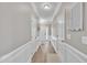 Bright hallway with fresh paint and modern trim that leads into the living area at 342 Westgrove Ct, Durham, NC 27703