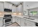 Modern kitchen featuring stainless steel appliances, white cabinets, and sleek countertops at 342 Westgrove Ct, Durham, NC 27703