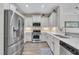 Modern kitchen featuring stainless steel appliances, white cabinets, and sleek countertops at 342 Westgrove Ct, Durham, NC 27703