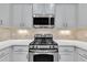 Kitchen features stainless steel appliances, granite countertops, and tiled backsplash at 342 Westgrove Ct, Durham, NC 27703