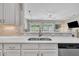 Modern kitchen with stainless steel appliances, white cabinetry, and quartz countertops at 342 Westgrove Ct, Durham, NC 27703