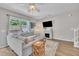 Cozy living room with sofa, fireplace, television, and natural light at 342 Westgrove Ct, Durham, NC 27703