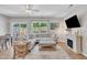 Spacious living room with large sectional, fireplace, and backyard view at 342 Westgrove Ct, Durham, NC 27703