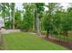 Manicured lawn with retaining wall and decorative landscaping at 4105 Bankshire Ln, Raleigh, NC 27603