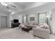Inviting carpeted basement with a sectional sofa, ottoman, TV, and natural light from nearby windows at 4105 Bankshire Ln, Raleigh, NC 27603