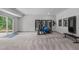 Basement area featuring exercise equipment and mirrors, next to a sliding glass door leading to the outdoors at 4105 Bankshire Ln, Raleigh, NC 27603