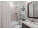 Clean, updated bathroom features a shower-tub, sink with granite countertop, and neutral wall and floor tiling at 4105 Bankshire Ln, Raleigh, NC 27603