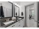 Bathroom featuring double sink vanity with black countertops and views into the bedroom at 4105 Bankshire Ln, Raleigh, NC 27603