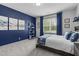 Stylish bedroom with blue accent wall, modern decor, and a queen size bed at 4105 Bankshire Ln, Raleigh, NC 27603