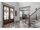 Stunning foyer with wood floors, glass front doors, staircase, and designer accents at 4105 Bankshire Ln, Raleigh, NC 27603