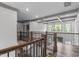 Open upstairs hallway with hardwood floors, wood and metal railings, and views of rooms below at 4105 Bankshire Ln, Raleigh, NC 27603