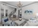 Bright and spacious living room with hardwood floors, elegant furnishings, and a staircase leading to the second floor at 4105 Bankshire Ln, Raleigh, NC 27603