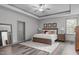 Spacious main bedroom with hardwood floors, tray ceiling, plenty of natural light, and neutral decor at 4105 Bankshire Ln, Raleigh, NC 27603
