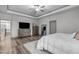Bright main bedroom with carpet, neutral decor, tray ceilings, plenty of closet space, and good natural lighting at 4105 Bankshire Ln, Raleigh, NC 27603