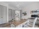 Light-filled home office with desk, chair, shelves and open french doors showing entry hallway and staircase at 4105 Bankshire Ln, Raleigh, NC 27603