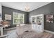 Well-lit home office featuring custom built-ins, hardwood floors, neutral walls, and large windows with a view at 4105 Bankshire Ln, Raleigh, NC 27603