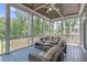 Relaxing screened porch featuring comfortable seating, a ceiling fan, and picturesque views of the surrounding greenery at 4105 Bankshire Ln, Raleigh, NC 27603