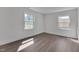 Empty bedroom featuring wood floors and two windows allowing natural light at 414 Craven St, Durham, NC 27704