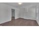 Well-lit bedroom showcasing new hardwood floors, fresh paint, and a view into the hallway at 414 Craven St, Durham, NC 27704