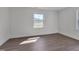 Bright bedroom with wood floors and a large window offering a pleasant view at 414 Craven St, Durham, NC 27704