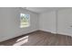 Bedroom offers vinyl floors, trim and a light-filled window at 414 Craven St, Durham, NC 27704