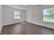 This bright bedroom features hardwood floors, fresh paint, and multiple windows for natural light at 414 Craven St, Durham, NC 27704