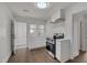 Modern kitchen featuring white cabinets, stainless steel appliances, and vinyl floors at 414 Craven St, Durham, NC 27704
