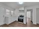 Bright kitchen showcasing new countertops, white cabinets, stainless steel appliances, and ample light at 414 Craven St, Durham, NC 27704