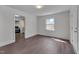 Bright living room with neutral walls and adjacent kitchen with stainless appliances at 414 Craven St, Durham, NC 27704