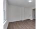 Empty room provides versatility, boasting a window and vinyl floors at 414 Craven St, Durham, NC 27704