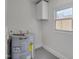 This utility room contains a modern water heater and one window at 414 Craven St, Durham, NC 27704