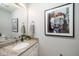 Stylish bathroom with a granite vanity top, modern faucet, and playful art, combining functionality with personality at 4604 Townesbury Ln, Raleigh, NC 27612