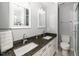 Bathroom features double vanity with granite countertops and framed mirrors at 4604 Townesbury Ln, Raleigh, NC 27612