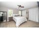 Bright bedroom with ceiling fan, carpet, and window with natural light at 4604 Townesbury Ln, Raleigh, NC 27612