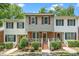 Charming townhouse with a brick facade, tidy landscaping, and a welcoming front porch in a residential setting at 4604 Townesbury Ln, Raleigh, NC 27612