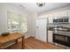 Bright kitchen with white cabinets, stainless steel appliances, and a dining table, ideal for everyday cooking and meals at 4604 Townesbury Ln, Raleigh, NC 27612