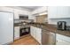 Well-equipped kitchen with stainless steel appliances, granite countertops, and white cabinets for modern cooking at 4604 Townesbury Ln, Raleigh, NC 27612