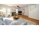 Comfortable living room featuring a sectional sofa, fireplace, and wood flooring, designed for relaxation and entertainment at 4604 Townesbury Ln, Raleigh, NC 27612