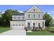 Charming two-story home featuring a welcoming porch and attached two-car garage at 47 Bluebell St, Sanford, NC 27330