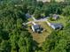 Aerial view of a neighborhood, homes surrounded by lush green trees at 486 S Denise Ave, Coats, NC 27521