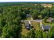 Aerial view of the property, nestled among the trees with a spacious backyard at 486 S Denise Ave, Coats, NC 27521