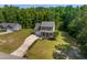 Aerial view of a charming two-story home on a spacious lot, surrounded by lush greenery and mature trees at 486 S Denise Ave, Coats, NC 27521