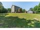 Expansive backyard featuring a screened porch and play set on a lush green lawn at 486 S Denise Ave, Coats, NC 27521