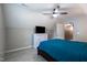 Comfortable bedroom featuring a ceiling fan, window, and white dresser with a television at 486 S Denise Ave, Coats, NC 27521