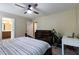 Bedroom with neutral walls, ceiling fan, large bed, and dedicated desk space for work or hobbies at 486 S Denise Ave, Coats, NC 27521